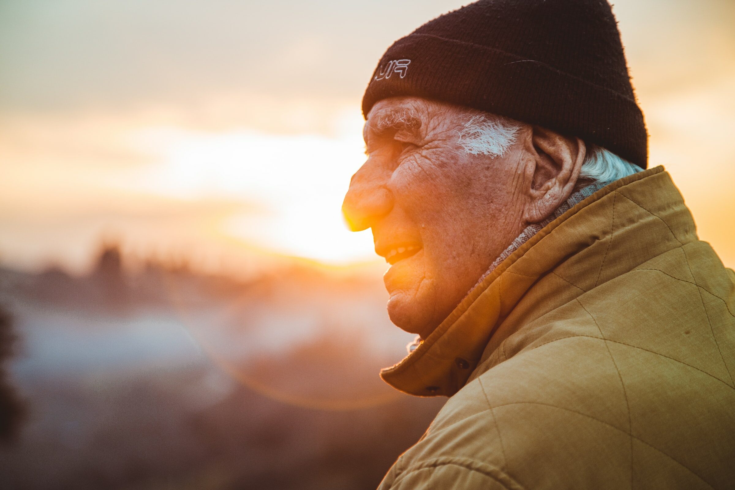 senior man next to a sunset view