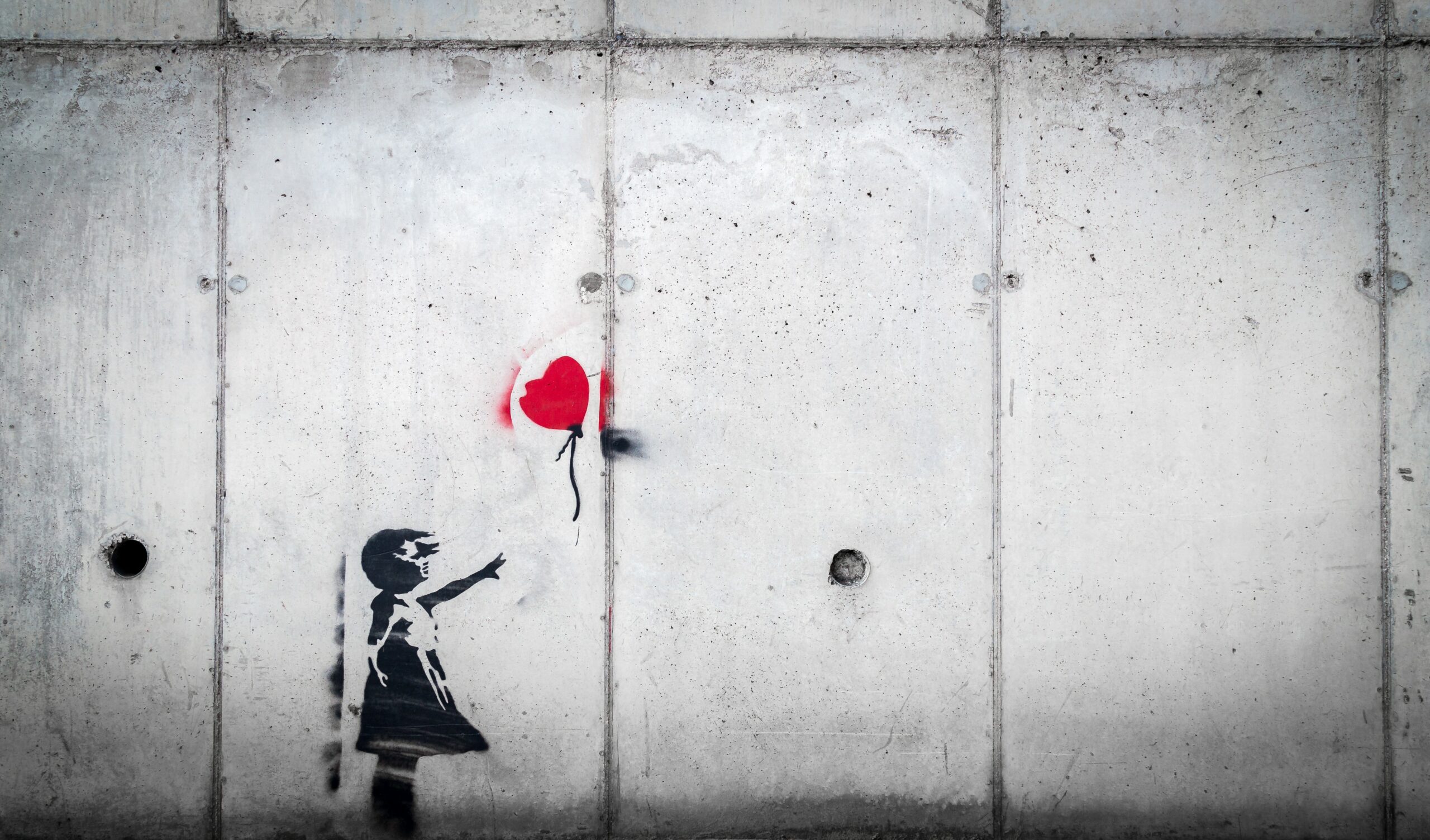 wall art of little girl reaching for heart balloon