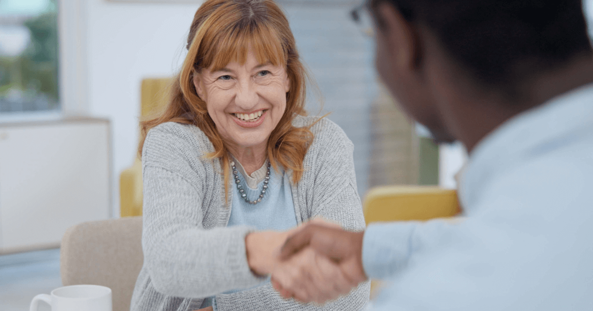 Woman shaking physicians hand Paying for the Cost of Memory Care